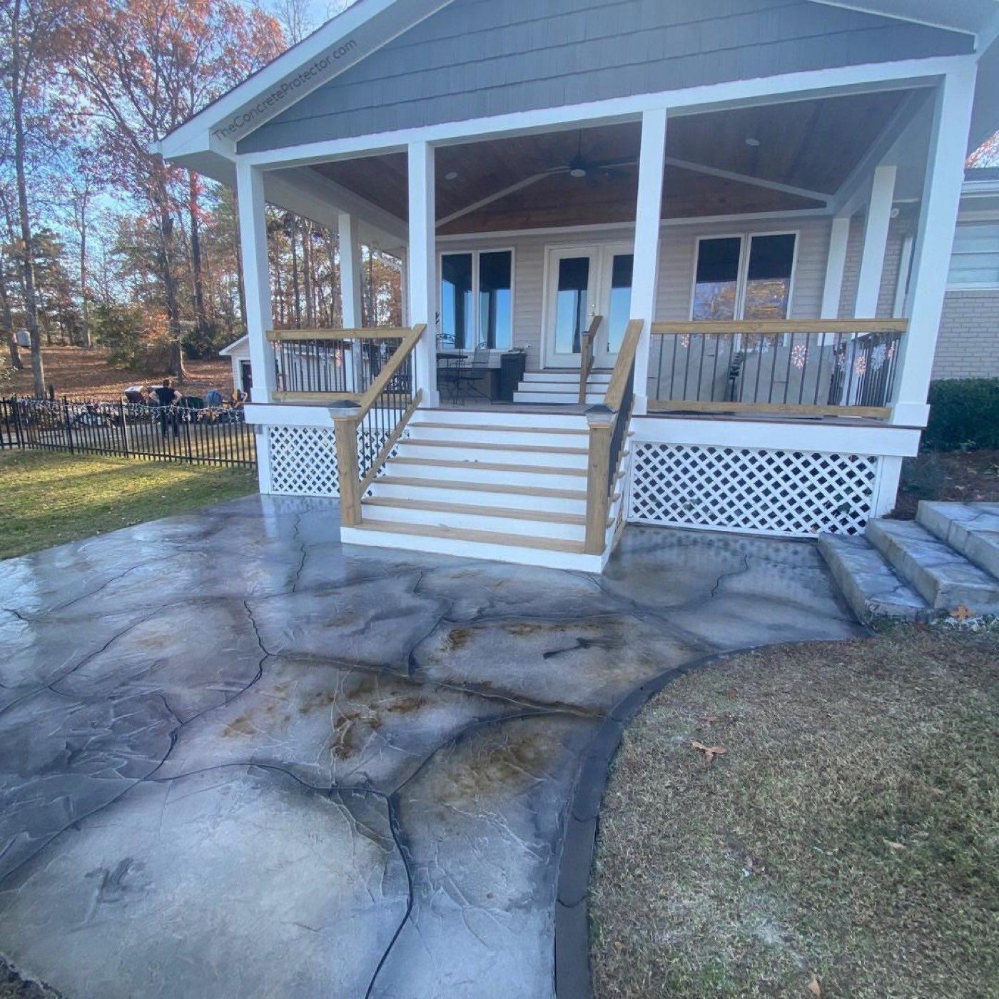Porch steps with flake coating and white columns