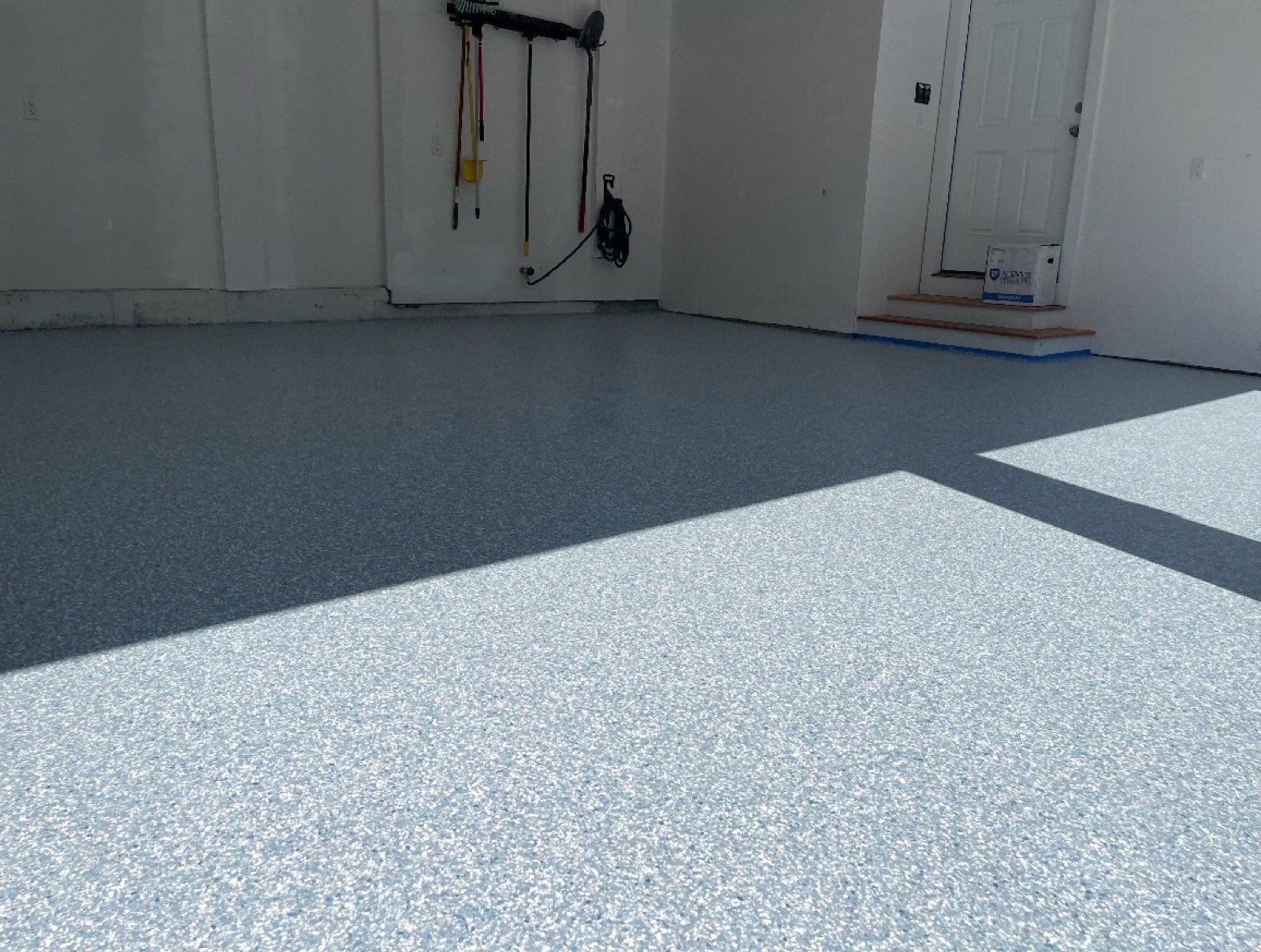 Residential garage after epoxy floor coating by Pinnacle Flooring